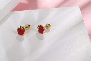 Close-up of red apple stud earrings with green leaves and gold-plated backings
