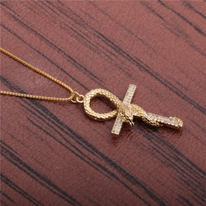 Vintage golden snake wrapped around cross pendant necklace with clear gemstones on box chain