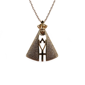 Golden crown figure cross pendant necklace with sparkling cubic zirconia on white background