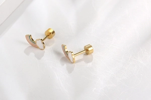 Detail of rainbow cloud earrings with gold metal finish and colorful enamel coating