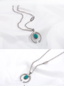 Macro detail of vintage titanium steel necklace with oval turquoise stone pendant