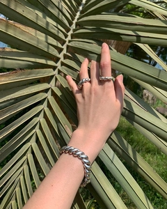 Close-up of S925 sterling silver rope twist ring and matching bracelet on model hand