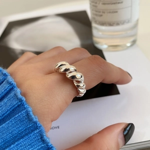 Close-up of a double-layer twisted sterling silver rope ring on a model's hand