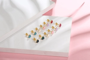 Macro detail of multicolored heart stud earrings with secure gold screw back closures