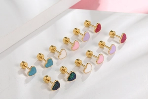 Macro detail of colorful glitter heart stud earrings with secure screw-back design