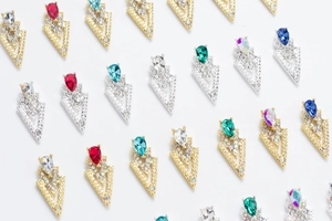 Detailed view of 3D V-shaped nail art charms with pear-cut gems and rhinestones