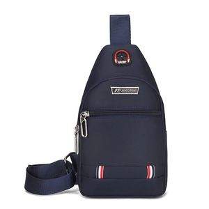 Detail of dark blue oxford sling bag with headphone jack, zipper pocket and stripe detail