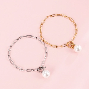 Gold and silver paperclip chain bracelets with large pearl drops and toggle clasps