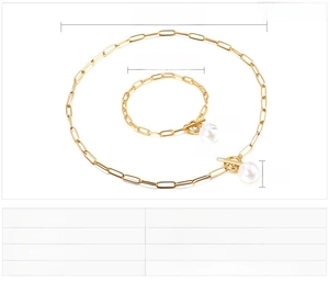 Detail of stainless steel paperclip chain jewelry set with pearl charms and OT toggle clasp