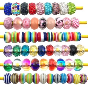 Macro view of assorted glass and crystal beads for jewelry making on a string