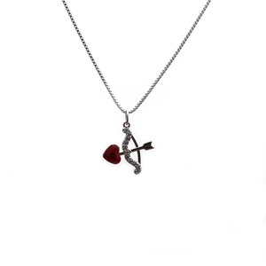 Detailed view of silver necklace with micro-pave zircon arrow through red heart pendant