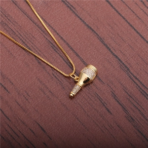 Golden micro-pave zircon microphone pendant necklace with box chain on wood background