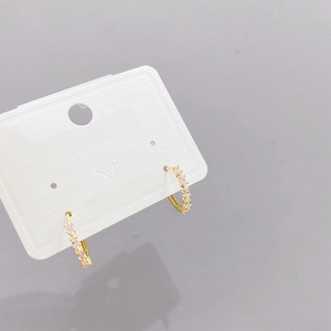 Three pairs of elegant gold hoop earrings set with micro-inlaid zircon on white card