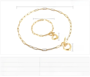 Detail view of gold heart pendant necklace and bracelet set with size measurements
