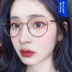 Close-up of model wearing retro round metal frame glasses with blue light blocking lenses