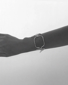 Detailed view of minimalist irregular geometric silver bangle with fluid design