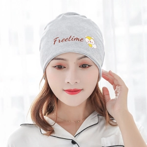 Light gray knit beanie with Freetime fox patch worn by a model in a bright setting