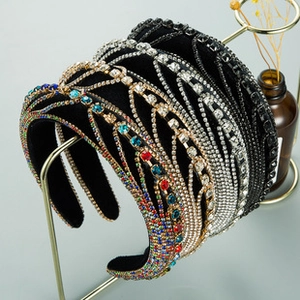 Close-up of sparkling rhinestone headbands on a metal rack with elegant dried flower decor