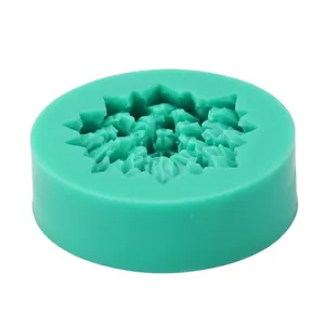 Top view of green round silicone mold featuring detailed floral and snowflake patterns