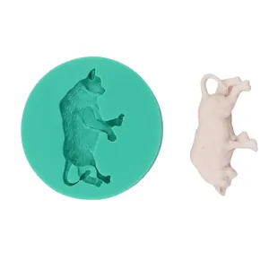 Detailed view of green cat-shaped silicone mold with its white DIY cake craft result