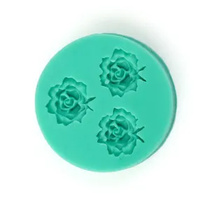 Detail view of round mint green silicone mold featuring three intricate rose patterns