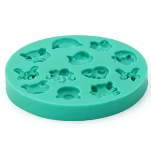 Detail view of mint green silicone mold with butterfly and fish shapes for DIY baking
