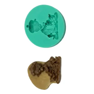 Detailed teal silicone mold and chocolate figurine showing precise texture details