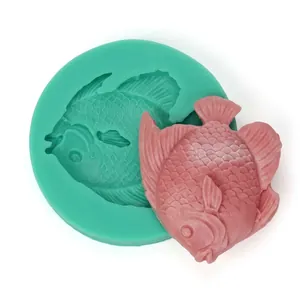 Detailed view of fish-shaped silicone mold and a pink fondant creation for cake decorating