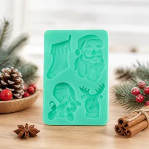 Close-up of a green silicone mold featuring Santa Claus, reindeer, and sock patterns