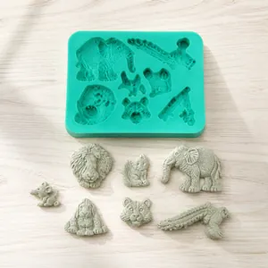 Green silicone mold featuring elephant, lion and giraffe shapes for DIY cake baking