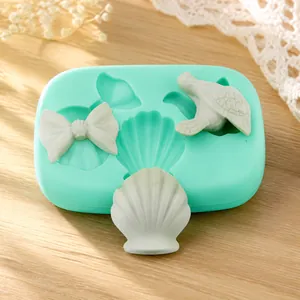 Green silicone fondant mold featuring detailed shell, bow, and bird shapes for DIY baking