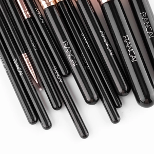 Detail of soft makeup brushes with black handles and rose gold metal ferrules