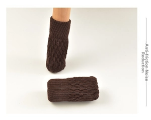 Close-up of thick knitted chair leg floor protectors in dark brown on wooden legs