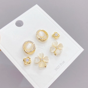 Three-pair gold S925 silver post earrings set with white cat eye stones and clover motifs