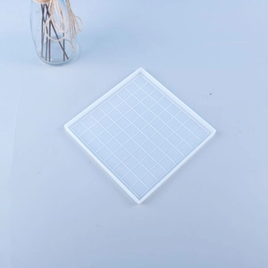 Close-up of translucent square chessboard silicone mold for DIY resin casting projects