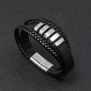 Macro detail of men's multilayer braided leather bracelet with stainless steel magnetic clasp