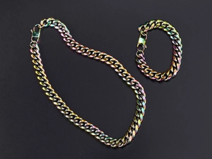 Detailed macro view of rainbow colored titanium steel Cuban link chain necklace and bracelet