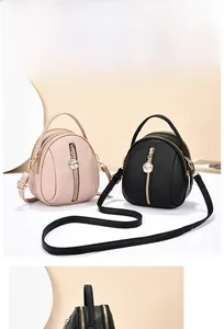 Detail of mini shell bag showing lychee pattern leather and gold rose charm pendant