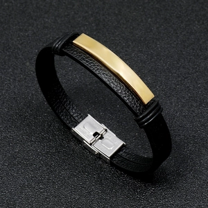 Detail of men's leather bracelet with gold plate and stainless steel clasp buckle