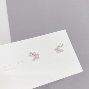 Macro detail of silver butterfly earrings with sparkling micro-pave cubic zirconia crystals