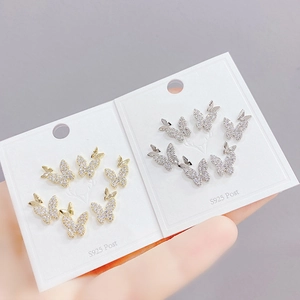 Detail showing S925 post butterfly stud earrings with micro-pave zircon on a display card