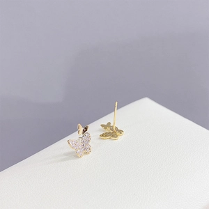 Macro shot of gold butterfly stud earring with sparkling pave cubic zirconia crystals