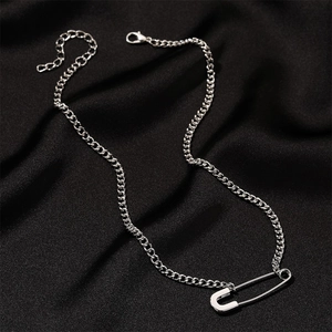 Detail of silver paperclip pendant with curb chain and lobster clasp on black background