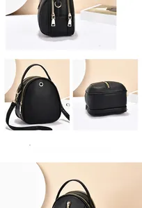 Detail of black pebbled leather mini backpack with gold hardware and dual zipper pockets