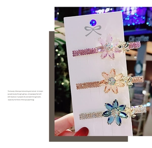 Detailed view of floral crystal hair clips with butterfly accents and rhinestones