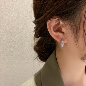 Micro-paved zircon geometric hoop earrings in sterling silver worn by model