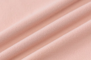 Detail of pink knitted fabric texture with soft drapes and high elasticity for dress