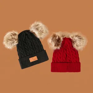 Kids warm knit hat with dual faux fur pom-poms in classic red and black colors