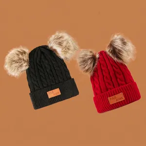 Red and black knit hats for kids with faux fur pom-poms and warm ear flaps