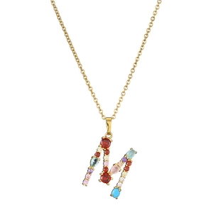 Detailed close-up of gold letter M necklace featuring vibrant multicolor gemstone pavé setting